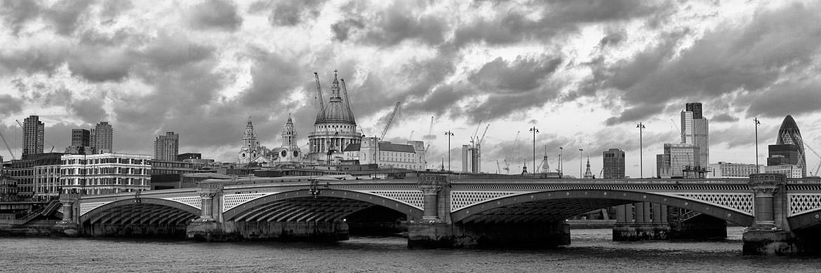 Clouds over Blackfriars Bridge and London skyline in black and white