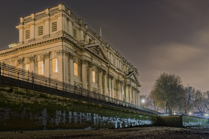 Greenwich Naval College seen from the River Thames at night.