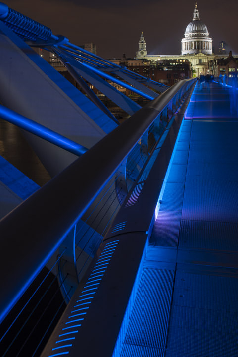 Long blue Millennium Bridge and St Pauls Cathedral at night
