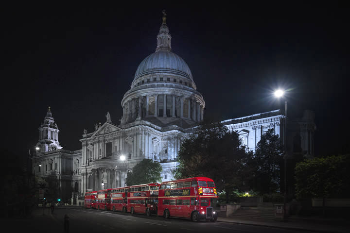 5 London buses in front of St Pauls Cathedral at night